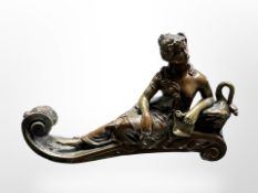 A 19th century hollow cast bronze figure of a lady reclining, length 16 cm.