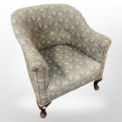 An early 20th century armchair on pad feet