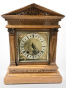 A late Victorian oak eight day bracket clock with pendulum and key, striking on a gong,