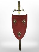 A reproduction sword and decorative shield, length 64 cm.