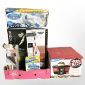 A group of boxed homewares including 8-in-1 cooker, Black and Decker dust buster, steam cleaner,