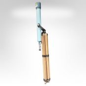 A vintage telescope on folding tripod stand.