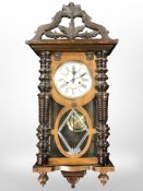 An early 20th century continental Vienna style wall timepiece, with pendulum and key, height 88 cm.