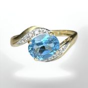 A 9ct gold blue zircon crossover ring, size U1/2 CONDITION REPORT: 2.