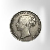 A Victorian 1852 silver shilling.