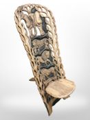 An African carved hardwood birthing chair.