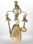 A brass fire companion set decorated with poodles,