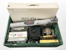 A Nintendo Gamecube, Wii Fit Plus, Nintendo scope gun and a group of Nintendo and Xbox video games.
