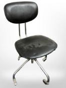 A chrome swivel chair and an industrial style metal standard lamp