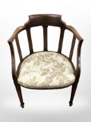 An Edwardian walnut armchair in floral upholstery.
