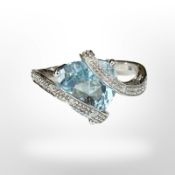 A 9ct white gold dress ring set with blue zircon and diamond chips,