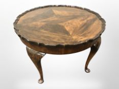 An early 20th century walnut scalloped edge low occasional table,