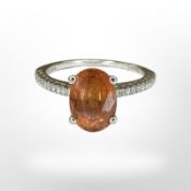 An 18ct white gold orange garnet and diamond ring,