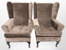 A pair of reproduction wingback arm chairs.