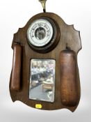 An Edwardian mahogany mirrored wall barometer, with two hanging brushes, height 37 cm.