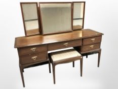 A Stag mirror backed dressing table and stool,