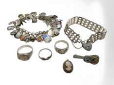 A silver charm bracelet, padlock bracelet, two signet rings,