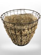 A metal basket with straw lining, height 49 cm.