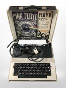 An Imperial electric typewriter and two reproduction tin Pink Floyd signs.