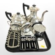 A silver plated four piece tea service, rose bowl, bottle coaster, set of six teaspoons,