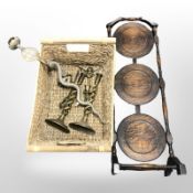 An Edwardian oak three tier cake stand, a whicker basket, a pair of brass barley twist candlesticks,