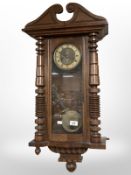 A 19th century continental walnut Vienna style wall clock, height 83 cm.