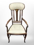 An Edwardian inlaid mahogany high backed armchair