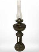 A brass oil lamp with figural support, height 70 cm.