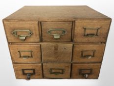 An Edwardian oak nine drawer index chest,
