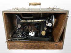 A Singer electric sewing machine, in box with lead. CONDITION REPORT: No pedal.