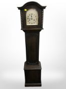 An early 20th century Granddaughter clock, with pendulum and key,
