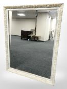 A painted and gilt bevelled overmantel mirror,