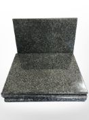 A set of six polished granite table placemats, each 40 cm x 30 cm.
