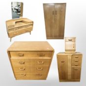 A 20th century G Plan oak and teak suite of bedroom furniture comprising double door wardrobe,
