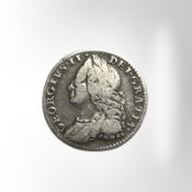A George II silver six pence.