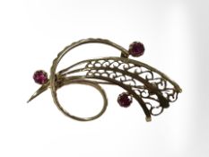 A 9ct yellow gold swirl bar brooch, set with synthetic rubies,