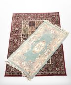 A Chinese woolen rug and a machine made rug