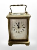 A French brass carriage timepiece, with platform escapement, height 14 cm including handle.