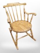 An early 20th century pine spindle back rocking chair.