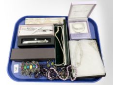 A group of costume jewellery, pens, necklaces,