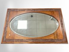 An Edwardian Art Nouveau carved walnut over mantle mirror, 123 cm x 76 cm.