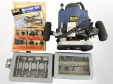 A Powercraft PBF-1050N router and three boxes of router bits.
