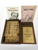 A Mah-Jong set in teak box with instructions.