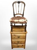 A modern pine three drawer bedside chest and a Victorian walnut chair.