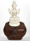 An oriental lacquered wood caddy, height 29 cm, and a porcelain figure of Buddha in lotus pose.