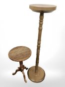 A turned wooden plant stand and a carved Eastern tripod table