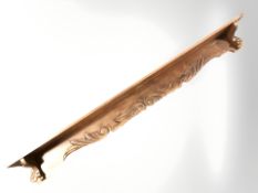 An early 20th century carved and stained pine wall shelf, length 190 cm.