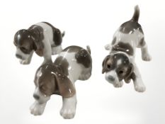 Three Lladro puppies, largest 15 cm long.