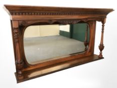 A late Victorian carved walnut over mantel mirror,