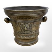 A bronze mortar in the 17th century style, with twin bust handles, bearing date 1630, height 20cm.
